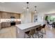 Modern kitchen with stainless steel appliances, pendant lighting, and a large island with bar stool seating at 2635 S Lamar Way, Lakewood, CO 80227