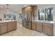 Bright kitchen with a stainless steel refrigerator, white counters, and views to the adjacent breakfast nook at 2635 S Lamar Way, Lakewood, CO 80227