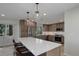 Well-lit kitchen featuring stainless steel appliances, white countertops, and ample cabinet space at 2635 S Lamar Way, Lakewood, CO 80227