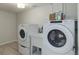 Well-lit laundry room boasts a utility sink and modern washer and dryer set at 2635 S Lamar Way, Lakewood, CO 80227