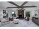 Cozy living room with a stone fireplace, beamed ceilings, and large windows with outdoor views at 2635 S Lamar Way, Lakewood, CO 80227