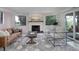 Living room with a white brick fireplace, leather sofa, accent chairs, and large rug at 2635 S Lamar Way, Lakewood, CO 80227