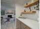 Bright living room features a white painted brick fireplace and open access to the entertaining area at 2635 S Lamar Way, Lakewood, CO 80227