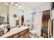 Bright bathroom with a shower-tub combination and ample counter space at 149 Jewel St, Brighton, CO 80603