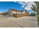 Exterior view of home featuring a fenced-in yard, well-maintained landscaping, and a two-car garage at 149 Jewel St, Brighton, CO 80603