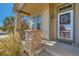 Charming front porch with a decorative wreath and comfortable seating at 149 Jewel St, Brighton, CO 80603