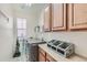 Bright laundry room with a washer, dryer, counter space, and storage cabinets at 149 Jewel St, Brighton, CO 80603
