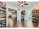 Open-concept living room features hardwood floors and leads to the kitchen and bathroom at 149 Jewel St, Brighton, CO 80603