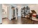 Spacious room with hardwood floors, featuring adjacent bathroom and storage shelves at 149 Jewel St, Brighton, CO 80603
