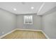 Finished basement room with light gray walls, recessed lighting, and a window for natural light at 7634 Navajo St, Denver, CO 80221