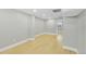 Spacious finished basement room with light hardwood floors and neutral color scheme at 7634 Navajo St, Denver, CO 80221