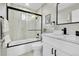 Updated bathroom with shower and tub combination, and a modern vanity sink at 7634 Navajo St, Denver, CO 80221