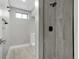 Bathroom with shower, white toilet, and vanity with gray walls and trim at 7634 Navajo St, Denver, CO 80221