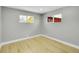 Cozy bedroom with hardwood floors, two windows and neutral color scheme at 7634 Navajo St, Denver, CO 80221