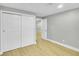 Bedroom features light hardwood floors, closet with sliding doors, and neutral color scheme at 7634 Navajo St, Denver, CO 80221