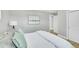 Relaxing bedroom with bed, white bedding, and a scenic landscape art piece on the wall at 7634 Navajo St, Denver, CO 80221