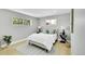 Bright bedroom with a queen bed, two windows, light wood floor and neutral color scheme at 7634 Navajo St, Denver, CO 80221