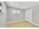 Bedroom featuring light hardwood floors, a large window, and a closet with sliding doors at 7634 Navajo St, Denver, CO 80221