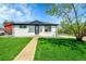 Charming single story home with a well-manicured lawn and inviting walkway at 7634 Navajo St, Denver, CO 80221