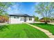 Charming single story home with a well-manicured lawn and inviting walkway at 7634 Navajo St, Denver, CO 80221
