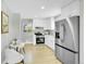 Modern kitchen with stainless steel appliances and bright white cabinets at 7634 Navajo St, Denver, CO 80221