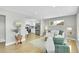 Bright living room with hardwood floors and an open layout leading to the kitchen at 7634 Navajo St, Denver, CO 80221
