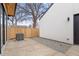 Backyard featuring a concrete patio, gravel area, wooden fence, and AC unit at 3049 S Cherokee St, Englewood, CO 80110