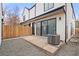 Backyard featuring a concrete patio, gravel area, and wooden fence at 3049 S Cherokee St, Englewood, CO 80110