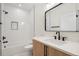 Modern bathroom with subway tile shower, marble countertop, and black fixtures at 3049 S Cherokee St, Englewood, CO 80110