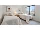 Bright bedroom featuring two beds, modern decor, and large window at 3049 S Cherokee St, Englewood, CO 80110