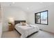 Cozy bedroom featuring a large window and neutral decor at 3049 S Cherokee St, Englewood, CO 80110