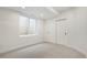 Bright bedroom featuring neutral carpet, white walls, a window, and sliding closet doors at 3049 S Cherokee St, Englewood, CO 80110