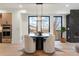 A cozy dining room features a round table set, modern lighting, and views of the outdoors at 3049 S Cherokee St, Englewood, CO 80110