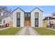 Modern home with black-framed windows, white stucco exterior, and manicured lawn with stone pathway at 3049 S Cherokee St, Englewood, CO 80110