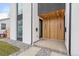 Modern home entrance featuring wood accents, sleek design, and manicured landscaping, with house numbers at 3049 S Cherokee St, Englewood, CO 80110