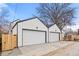 Two-car garage with white doors and a driveway at 3049 S Cherokee St, Englewood, CO 80110