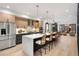 Modern kitchen features a large island with bar seating, stainless steel appliances, and open living space at 3049 S Cherokee St, Englewood, CO 80110
