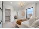 Bright main bedroom featuring a walk-in closet, chandelier, and black frame windows at 3049 S Cherokee St, Englewood, CO 80110