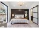 Serene main bedroom with stylish accent wall, modern lighting, and comfortable bed, creating a peaceful retreat at 3049 S Cherokee St, Englewood, CO 80110