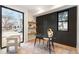 Stylish home office with hardwood floors, black accent wall, floating shelves, and marble desk at 3049 S Cherokee St, Englewood, CO 80110