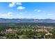 Expansive aerial view showcasing lush green landscape with mountains in the distance on a clear day at 311 W Lehow Ave # 3, Englewood, CO 80110