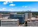 Aerial view of Swedish Medical Center, Denver skyline, and surrounding lush greenery under a blue sky at 311 W Lehow Ave # 3, Englewood, CO 80110