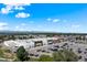 Aerial view of retail center with ample parking and surrounding neighborhood set against a mountain backdrop at 311 W Lehow Ave # 3, Englewood, CO 80110