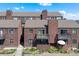 A multi-Gathering residential building with a balcony, landscaping, and a charming red wood facade at 311 W Lehow Ave # 3, Englewood, CO 80110