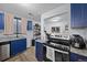 This compact kitchen is highly functional, featuring granite counters, modern appliances and blue cabinets at 311 W Lehow Ave # 3, Englewood, CO 80110