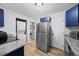 This cozy kitchen combines blue cabinetry, modern appliances, and convenient laundry facilities at 311 W Lehow Ave # 3, Englewood, CO 80110