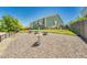 Green home featuring a gravel backyard with an ornamental fountain and small lawn, under a bright, sunny sky at 19771 E Wesley Pl, Aurora, CO 80013