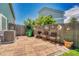Backyard patio setup with brick pavers, wood chairs, and privacy fence at 19771 E Wesley Pl, Aurora, CO 80013