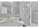 Bathroom featuring vanity, toilet, unique wall art, and tiled walk-in shower with shower head at 19771 E Wesley Pl, Aurora, CO 80013