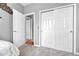 Bedroom featuring carpet, closet with sliding doors, and entrance to other rooms at 19771 E Wesley Pl, Aurora, CO 80013